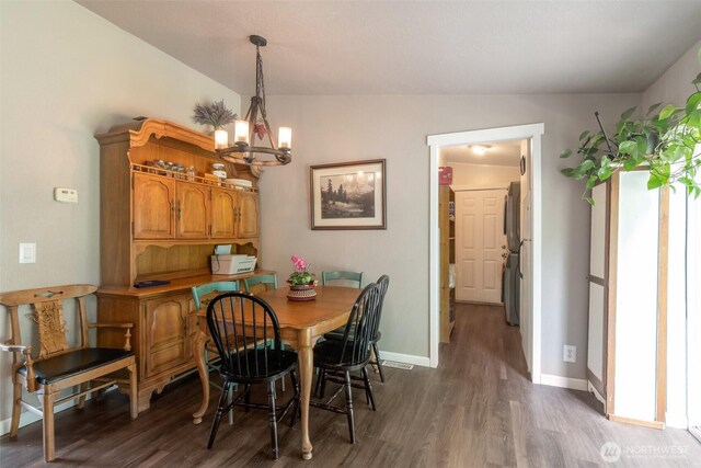 1707 Bonnie Ln, Camano Island, WA 98282 - dining area with a chandelier, wood finished floors, and baseboards