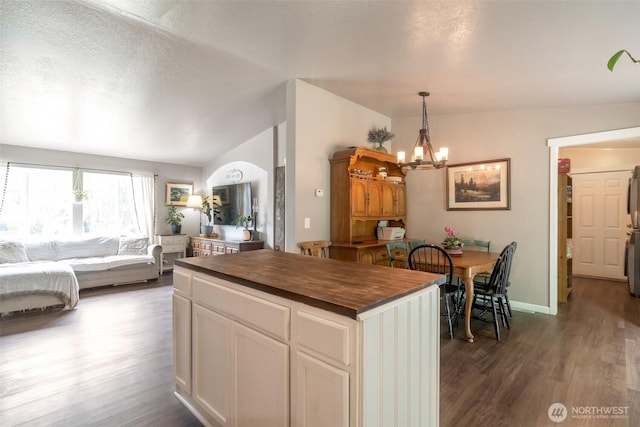 1707 Bonnie Ln, Camano Island, WA 98282 - kitchen with a chandelier, dark wood-style floors, butcher block countertops, open floor plan, and white cabinets