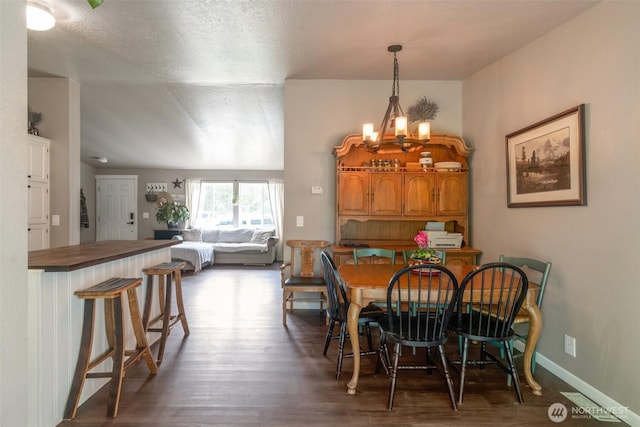 1707 Bonnie Ln, Camano Island, WA 98282 - dining space featuring dark wood-style floors, a chandelier, and baseboards
