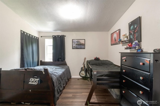 1707 Bonnie Ln, Camano Island, WA 98282 - bedroom featuring wood finished floors, a textured ceiling, and baseboards