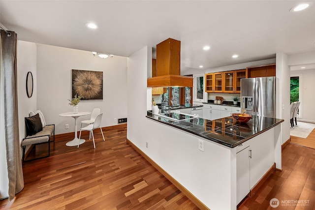 18527 Butternut Rd, Lynnwood, WA 98037 - kitchen featuring stainless steel fridge, dark countertops, recessed lighting, wood finished floors, and a peninsula