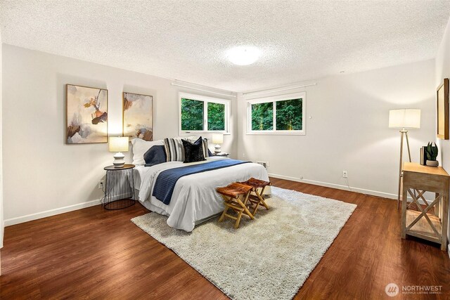 18527 Butternut Rd, Lynnwood, WA 98037 - bedroom with a textured ceiling and dark wood-style flooring