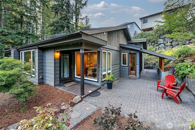 18527 Butternut Rd, Lynnwood, WA 98037 - back of house with a patio and a carport