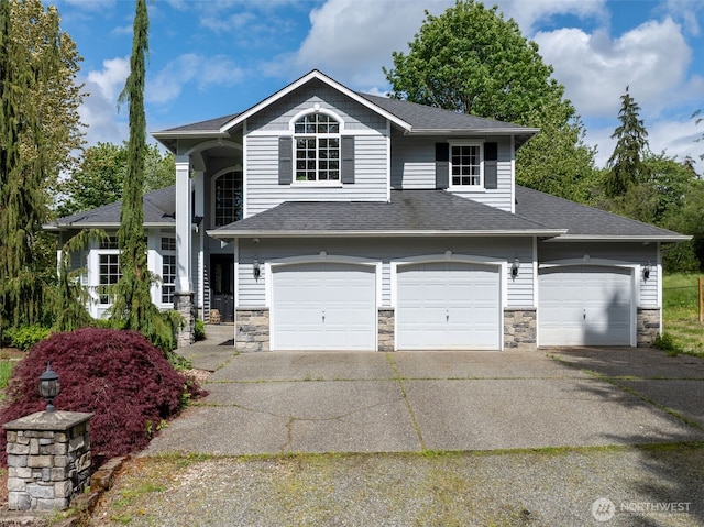 3831 171st Ave SE, Snohomish, WA 98290 - view of front facade with stone siding, driveway, a shingled roof, and an attached garage