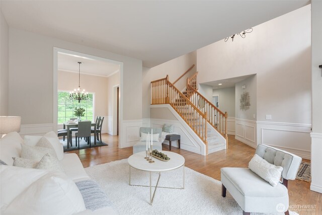 3831 171st Ave SE, Snohomish, WA 98290 - living area featuring stairs, a chandelier, wood finished floors, wainscoting, and a decorative wall