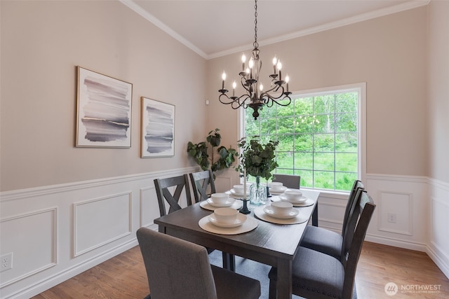 3831 171st Ave SE, Snohomish, WA 98290 - dining space with a chandelier, light wood-type flooring, a wainscoted wall, crown molding, and a decorative wall