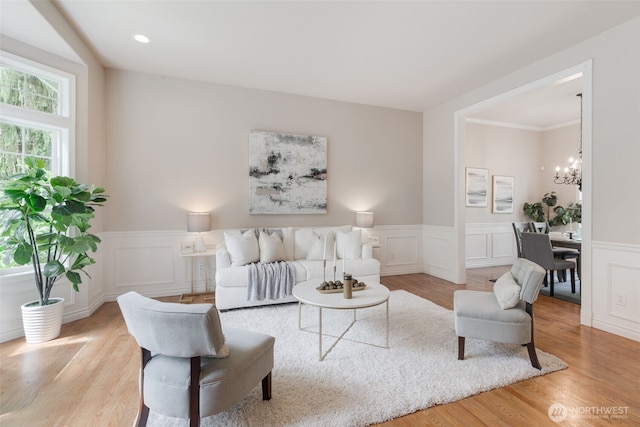 3831 171st Ave SE, Snohomish, WA 98290 - living area featuring a chandelier, a wainscoted wall, a decorative wall, and wood finished floors
