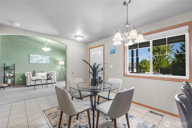 4507 Steves Aly, Mount Vernon, WA 98274 - dining space with light tile patterned flooring, baseboards, a chandelier, and arched walkways