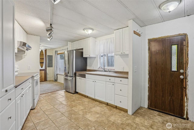 10132 228th Pl SE, Woodinville, WA 98077 - kitchen with white electric range oven, a sink, ventilation hood, stainless steel fridge, and white cabinets
