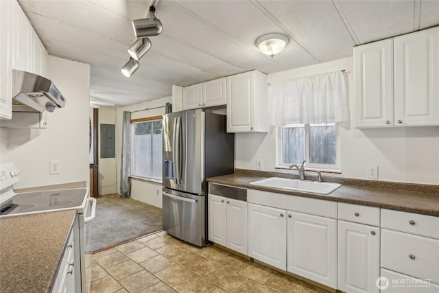 10132 228th Pl SE, Woodinville, WA 98077 - kitchen with electric range, a sink, exhaust hood, stainless steel refrigerator with ice dispenser, and light carpet