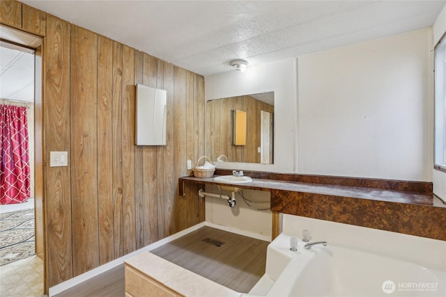 10132 228th Pl SE, Woodinville, WA 98077 - bathroom featuring wooden walls, a sink, and a tub
