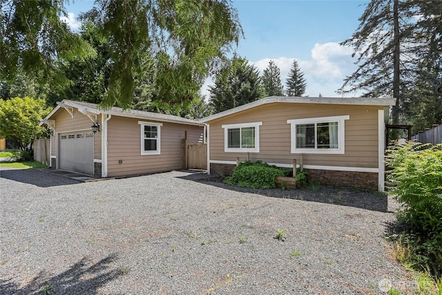 10132 228th Pl SE, Woodinville, WA 98077 - ranch-style house featuring an outdoor structure, a garage, and stone siding