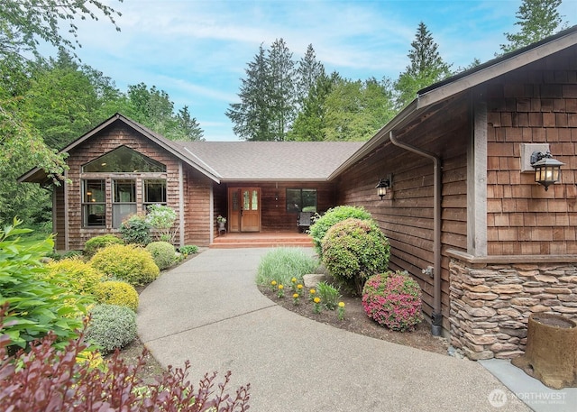 5707 316th St NW, Stanwood, WA 98292 - view of front of property with covered porch and stone siding
