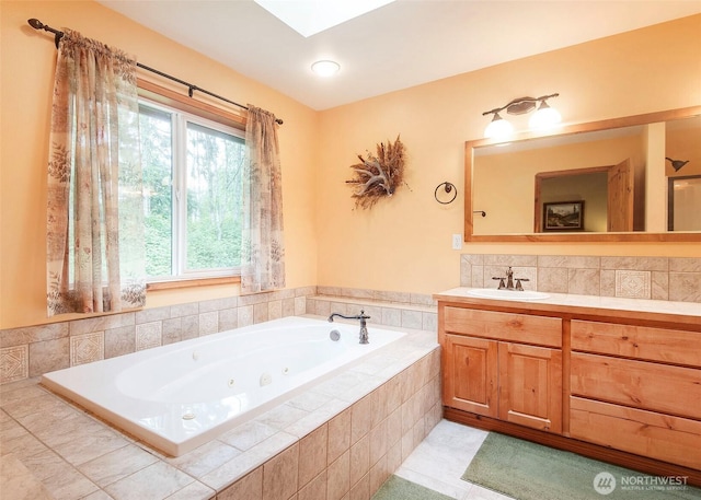 5707 316th St NW, Stanwood, WA 98292 - full bathroom featuring a jetted tub, vanity, a skylight, and decorative backsplash