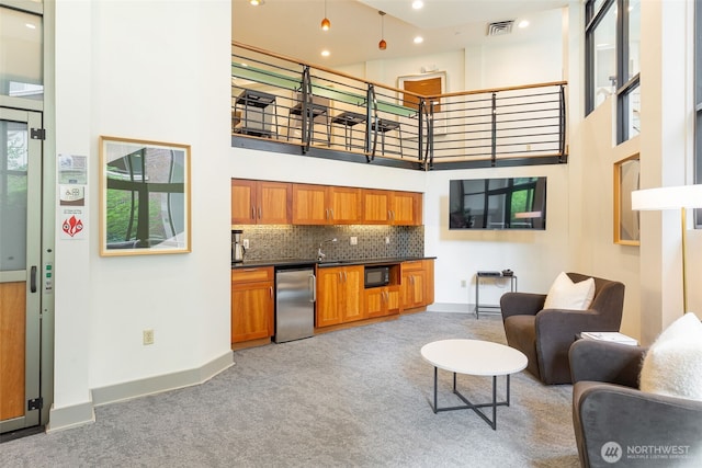 5450 Leary Ave NW Unit 442, Seattle, WA 98107 - living room featuring light colored carpet, a high ceiling, and recessed lighting
