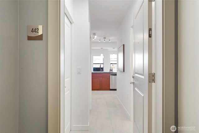 5450 Leary Ave NW Unit 442, Seattle, WA 98107 - hallway with baseboards and rail lighting