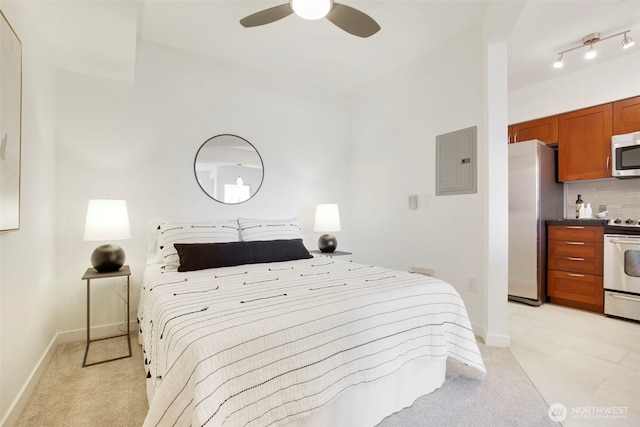 5450 Leary Ave NW Unit 442, Seattle, WA 98107 - bedroom featuring electric panel, freestanding refrigerator, light carpet, and a ceiling fan