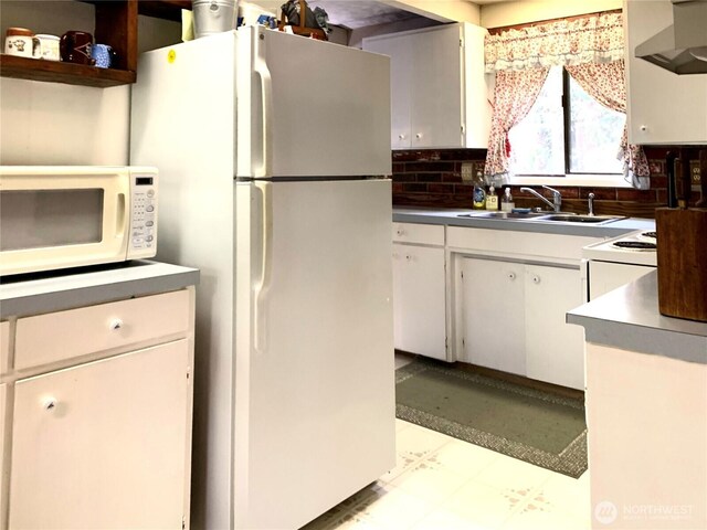 419 Draconis Ave SE, Ocean Shores, WA 98569 - kitchen with white appliances, a sink, ventilation hood, tile patterned floors, and white cabinetry