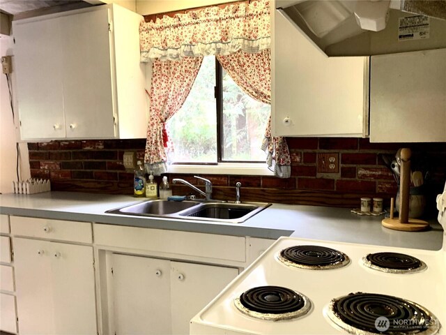 419 Draconis Ave SE, Ocean Shores, WA 98569 - kitchen with a sink, range hood, tasteful backsplash, white cabinets, and light countertops