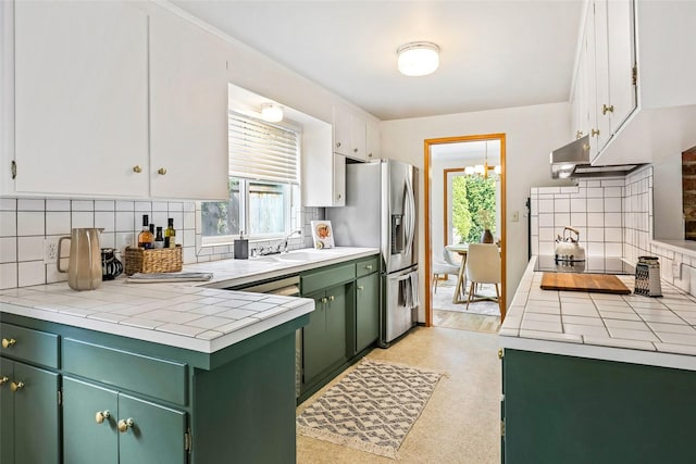 20010 3rd Ave NW, Shoreline, WA 98177 - kitchen featuring green cabinets, stainless steel fridge, tile counters, and backsplash