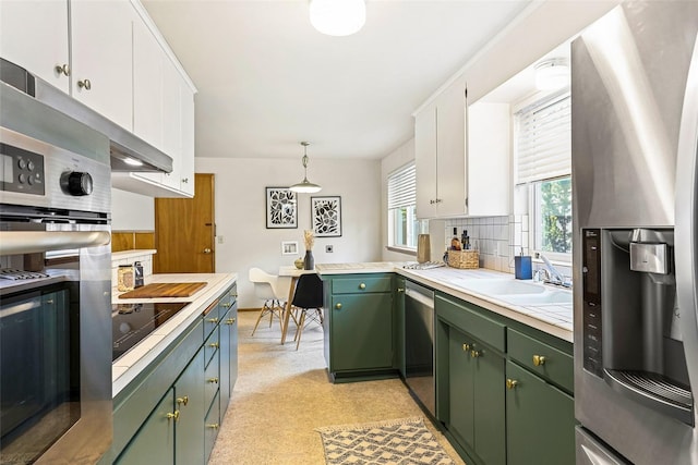 20010 3rd Ave NW, Shoreline, WA 98177 - kitchen featuring green cabinetry, stainless steel appliances, light countertops, white cabinets, and backsplash