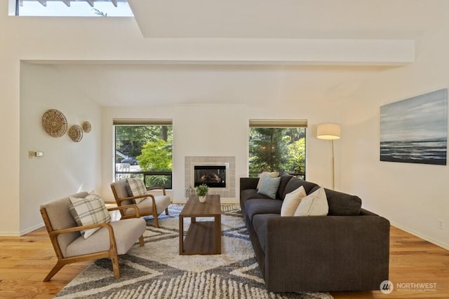5911 105th Ave NE, Kirkland, WA 98033 - living area with light wood finished floors, plenty of natural light, and a tiled fireplace