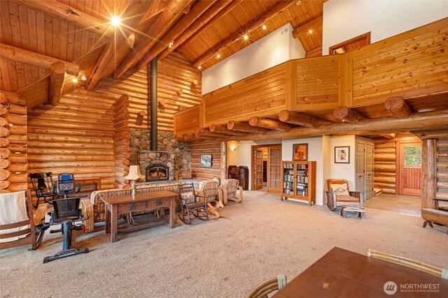 3528 Beaverton Valley Rd, Friday Harbor, WA 98250 - living room featuring wooden ceiling with exposed beams, log walls, carpet floors, high vaulted ceiling, and a wood stove