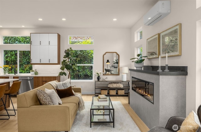 2727 50th Ave SW, Seattle, WA 98116 - living area featuring a wall mounted air conditioner, light wood-type flooring, recessed lighting, and a glass covered fireplace