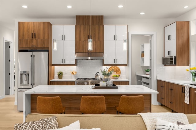 2727 50th Ave SW, Seattle, WA 98116 - kitchen with stainless steel appliances, white cabinets, decorative backsplash, light stone countertops, and recessed lighting