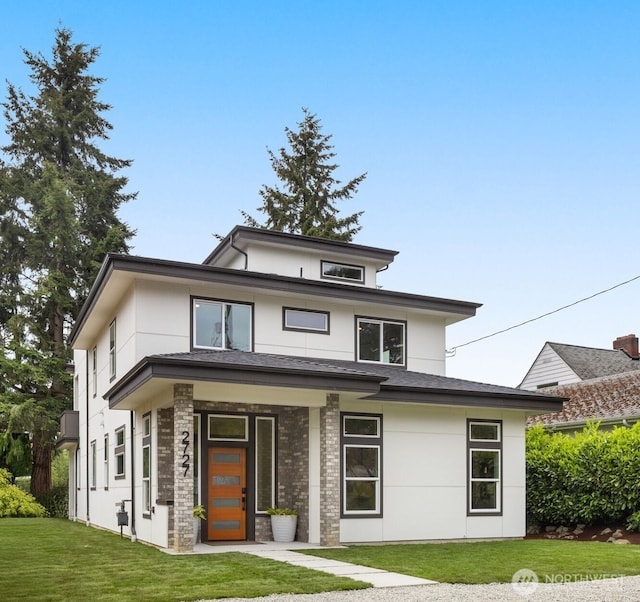 2727 50th Ave SW, Seattle, WA 98116 - view of front of home with a front lawn and stucco siding