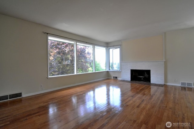2116 N 86th St, Seattle, WA 98103 - unfurnished living room with plenty of natural light, wood finished floors, and a fireplace