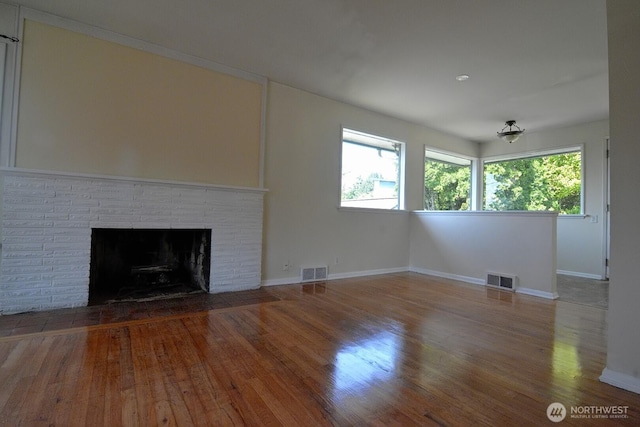 2116 N 86th St, Seattle, WA 98103 - unfurnished living room featuring wood finished floors and a brick fireplace