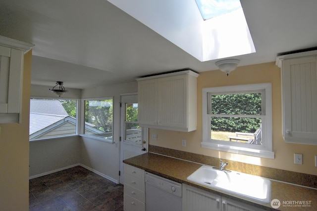 2116 N 86th St, Seattle, WA 98103 - kitchen featuring white dishwasher, a skylight, white cabinets, and dark countertops