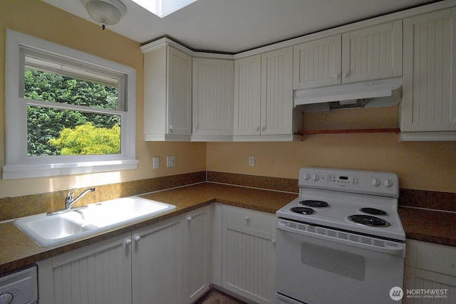2116 N 86th St, Seattle, WA 98103 - kitchen with electric stove, under cabinet range hood, white cabinets, washer / clothes dryer, and dark countertops