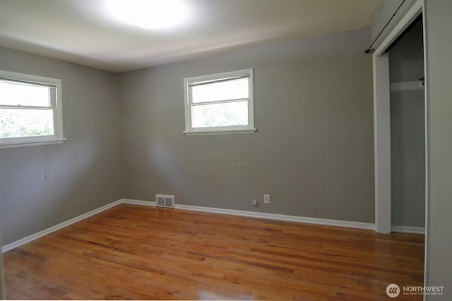 2116 N 86th St, Seattle, WA 98103 - unfurnished bedroom with multiple windows and light wood finished floors