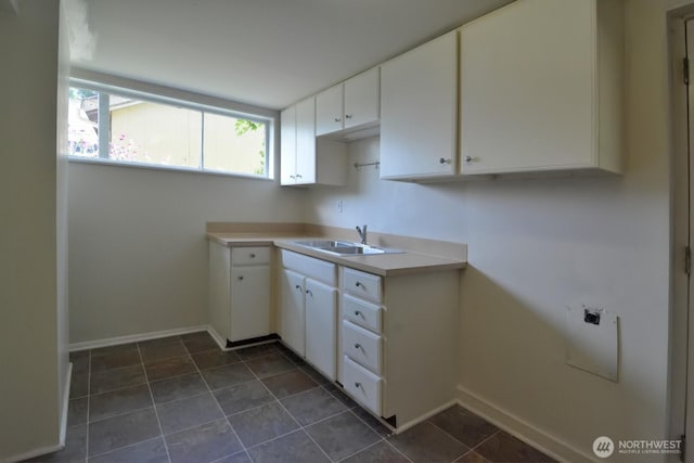 2116 N 86th St, Seattle, WA 98103 - kitchen with white cabinets, dark tile patterned floors, and light countertops