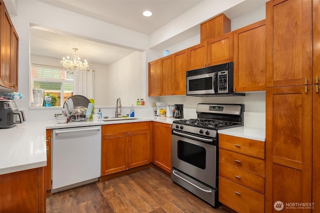 18526 36th Ave W Unit C, Lynnwood, WA 98037 - kitchen featuring appliances with stainless steel finishes, a sink, brown cabinets, and recessed lighting