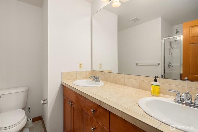 18526 36th Ave W Unit C, Lynnwood, WA 98037 - full bathroom with a stall shower, toilet, double vanity, and baseboards