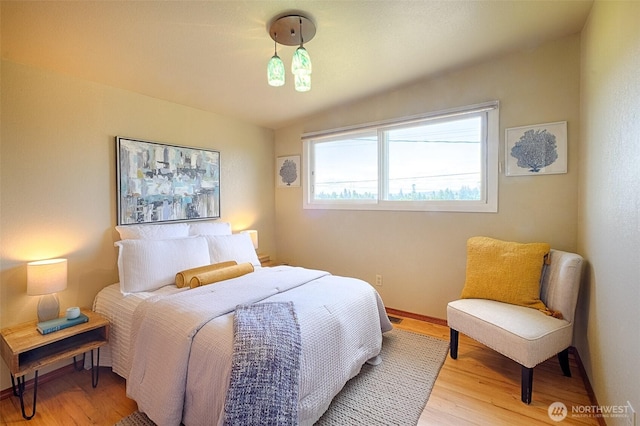 25718 16th Ave S, Des Moines, WA 98198 - bedroom featuring light wood-type flooring, lofted ceiling, and baseboards