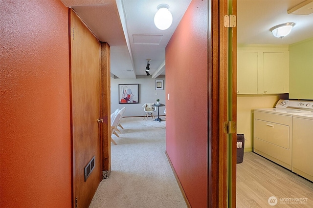 25718 16th Ave S, Des Moines, WA 98198 - corridor with washer and clothes dryer, a textured wall, and light carpet