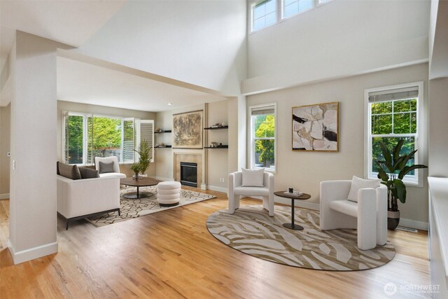 27309 SE 10th Ct, Sammamish, WA 98075 - living area featuring wood finished floors, a tile fireplace, and baseboards