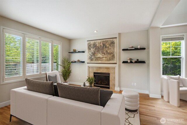 27309 SE 10th Ct, Sammamish, WA 98075 - living area with baseboards, light wood finished floors, and a fireplace