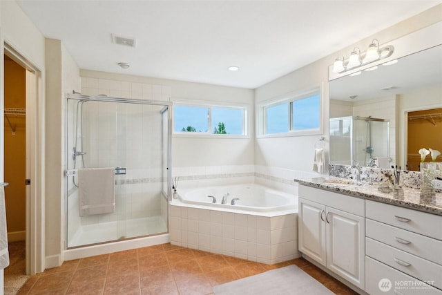 27309 SE 10th Ct, Sammamish, WA 98075 - bathroom featuring a spacious closet, vanity, a garden tub, a stall shower, and tile patterned floors
