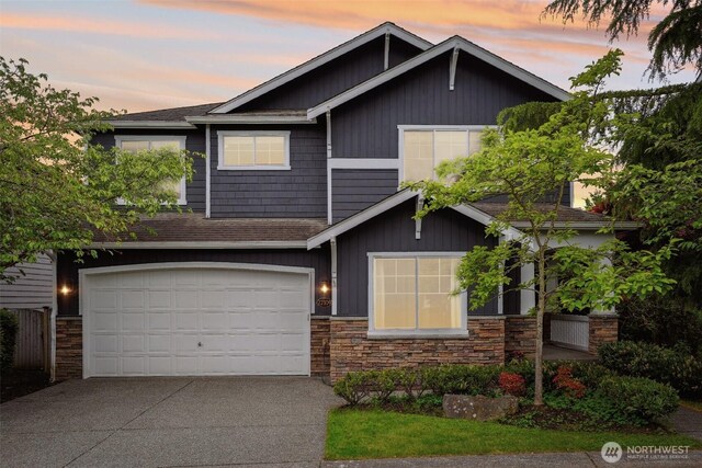 27309 SE 10th Ct, Sammamish, WA 98075 - craftsman-style home featuring stone siding, concrete driveway, roof with shingles, and an attached garage