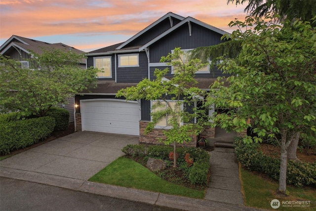 27309 SE 10th Ct, Sammamish, WA 98075 - view of front of home featuring driveway, an attached garage, and stone siding
