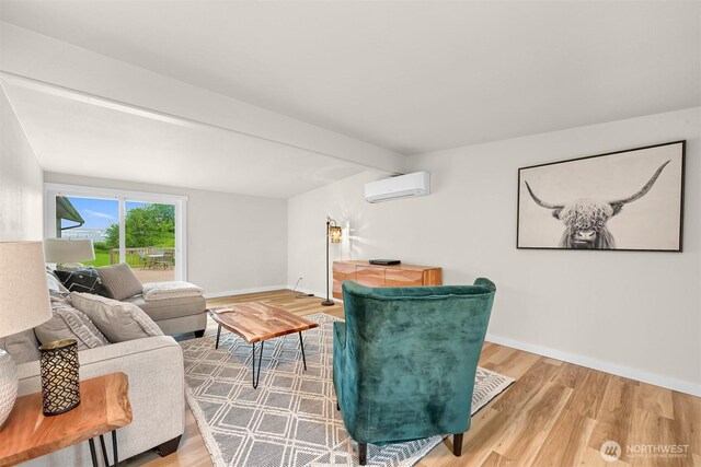 1005 Johnson St, Sumas, WA 98295 - living room with a wall unit AC, wood finished floors, baseboards, and beam ceiling
