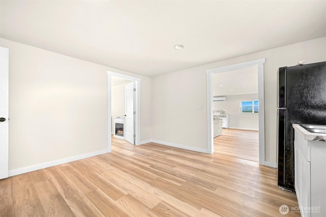 1005 Johnson St, Sumas, WA 98295 - empty room with light wood-style floors, baseboards, a wall mounted air conditioner, recessed lighting, and washer / dryer