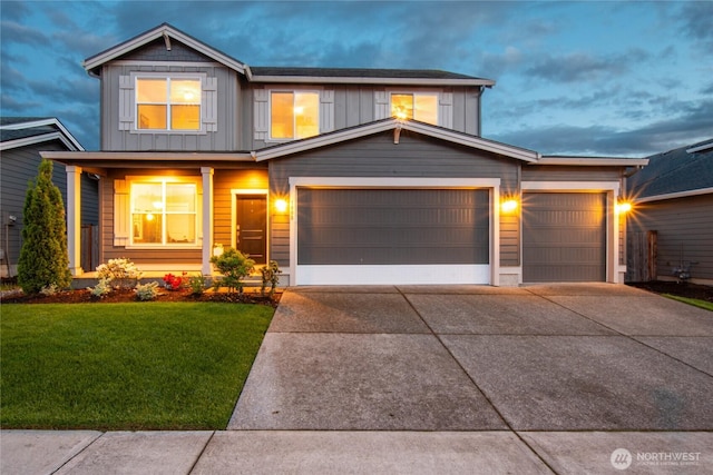 1009 NE 13th St, Battle Ground, WA 98604 - view of front of home featuring board and batten siding, driveway, a front yard, and a garage
