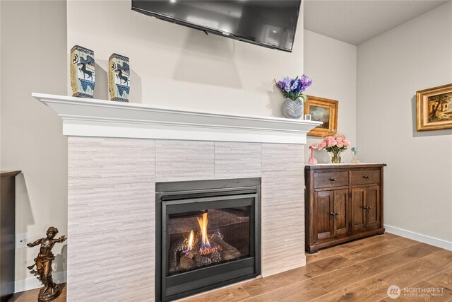 1009 NE 13th St, Battle Ground, WA 98604 - detailed view of wood finished floors, baseboards, and a tiled fireplace