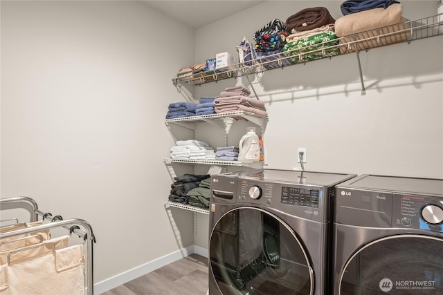 1009 NE 13th St, Battle Ground, WA 98604 - washroom featuring independent washer and dryer, wood finished floors, and baseboards